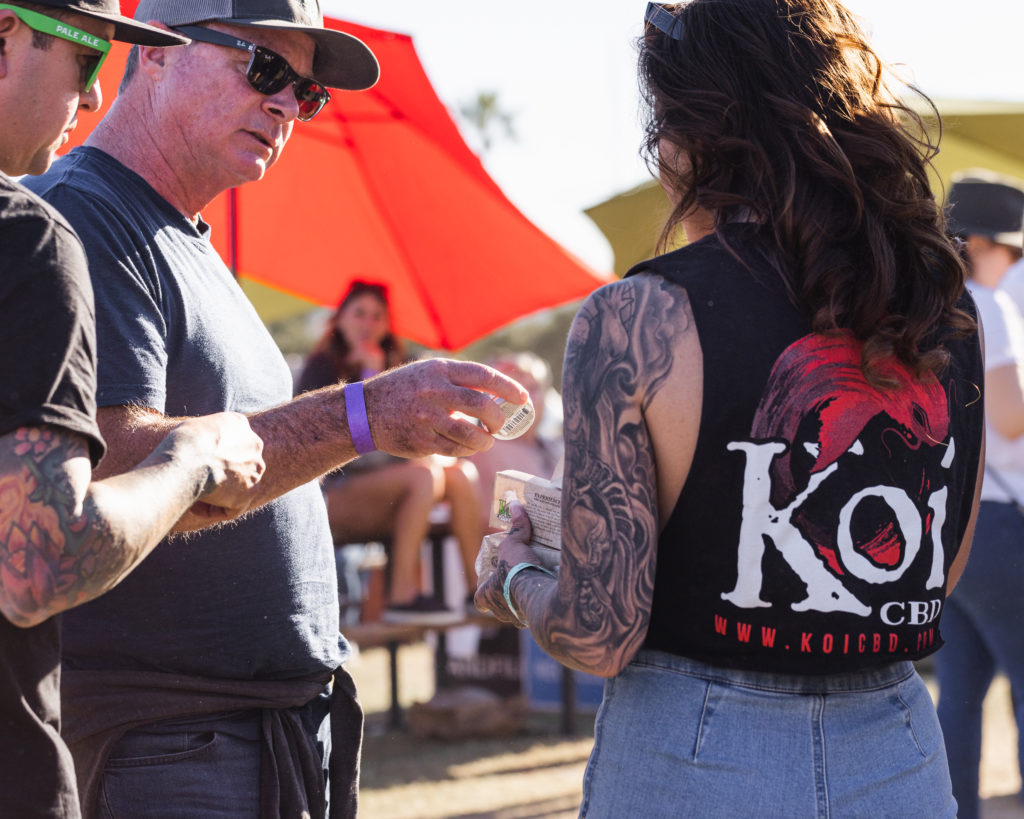 Showing a customer Koi CBD Healing Balm at Cali Vibes